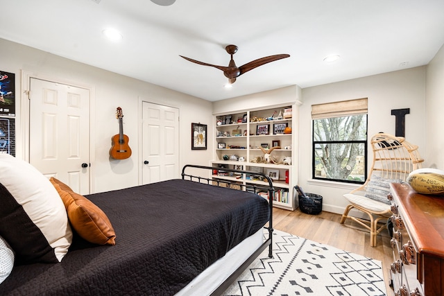 bedroom featuring recessed lighting, light wood-style flooring, a ceiling fan, and baseboards