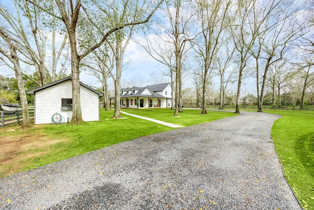 exterior space with driveway, a front yard, and fence