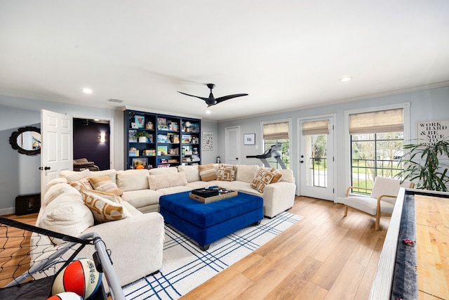 living room featuring recessed lighting, light wood-style floors, and ornamental molding