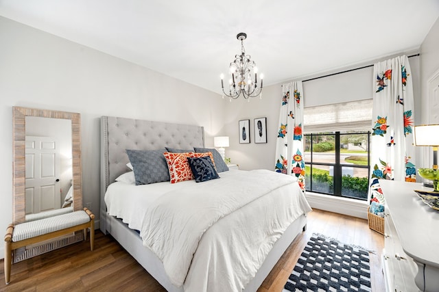 bedroom with light wood finished floors and a notable chandelier