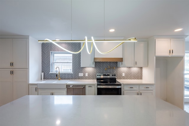 kitchen featuring a sink, white cabinetry, backsplash, and stainless steel appliances