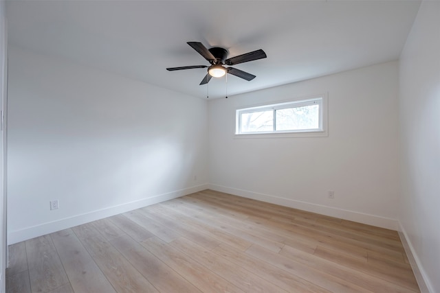 empty room featuring baseboards, light wood finished floors, and ceiling fan