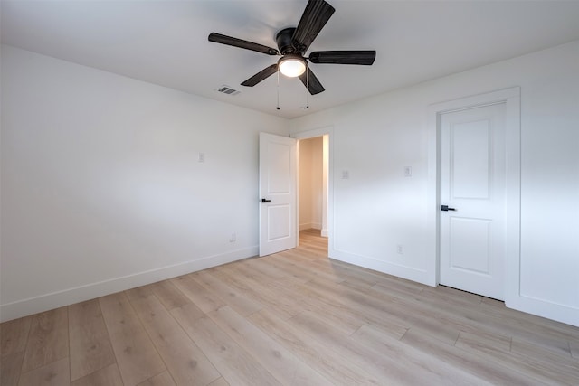 unfurnished bedroom with visible vents, a ceiling fan, light wood-type flooring, and baseboards