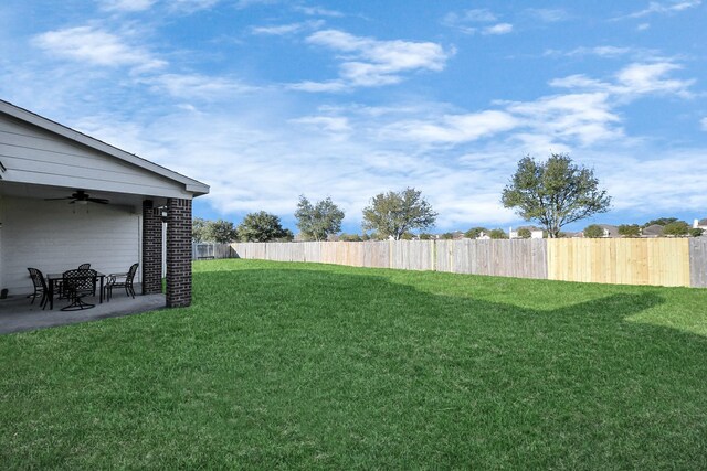 view of yard featuring a patio area, fence, and ceiling fan