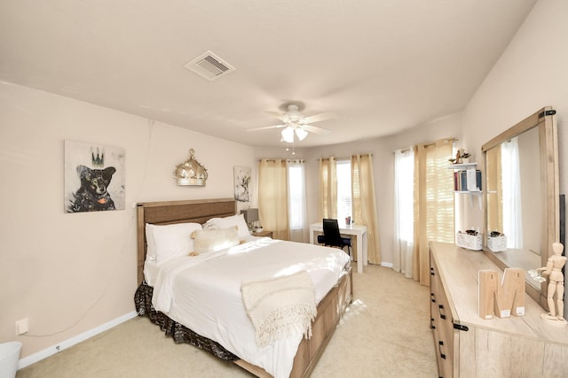 bedroom with light carpet, visible vents, ceiling fan, and baseboards