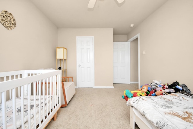 carpeted bedroom with baseboards and a ceiling fan