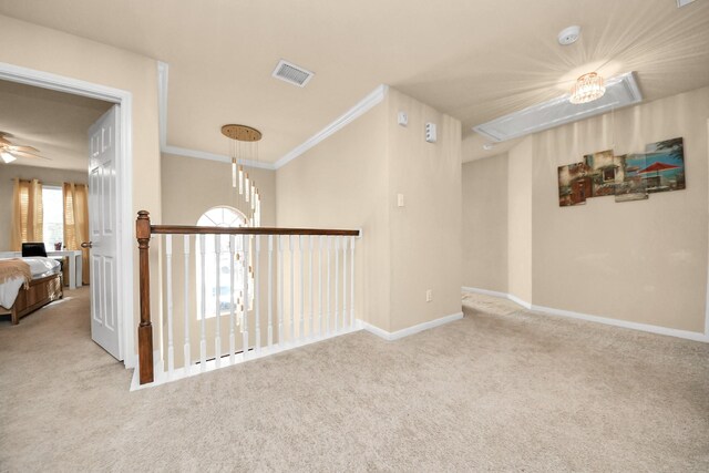 unfurnished room featuring visible vents, crown molding, baseboards, and carpet floors