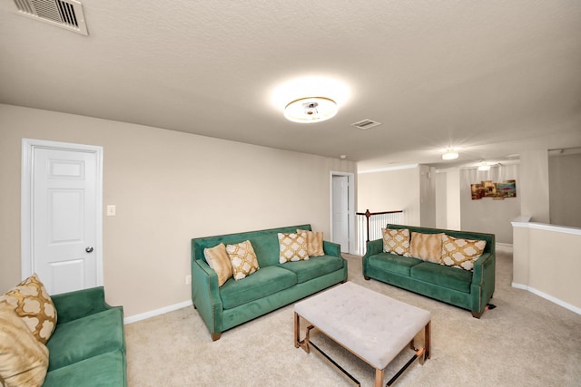 living area with visible vents, baseboards, and carpet