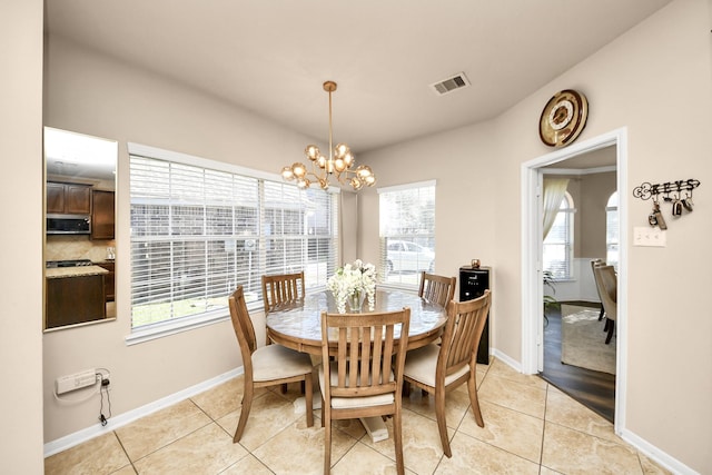 dining room with an inviting chandelier, light tile patterned flooring, baseboards, and visible vents