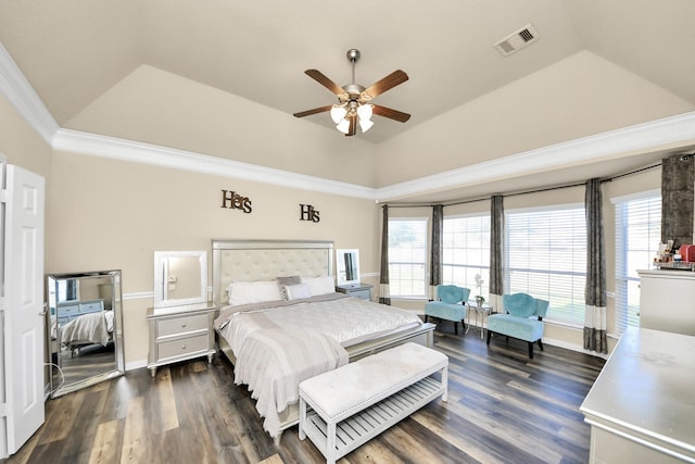 bedroom with visible vents, a raised ceiling, multiple windows, and dark wood-style floors