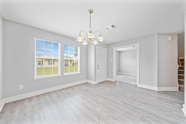 unfurnished dining area with stairway, baseboards, visible vents, and light wood finished floors