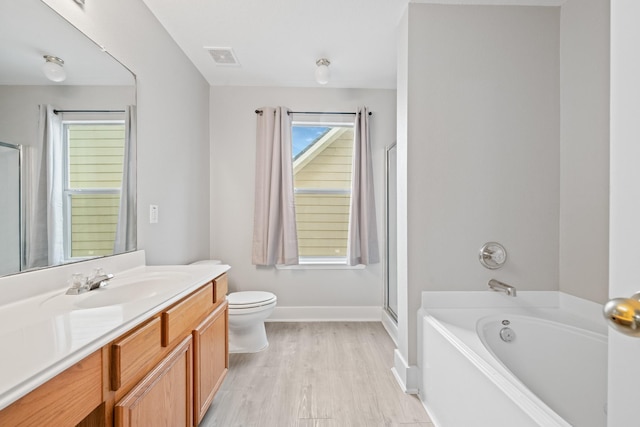 full bathroom featuring vanity, a bath, baseboards, toilet, and a shower with door