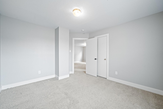 unfurnished bedroom with carpet, baseboards, and a closet