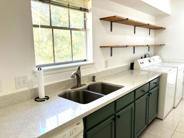 kitchen with a sink, green cabinets, light stone countertops, independent washer and dryer, and open shelves