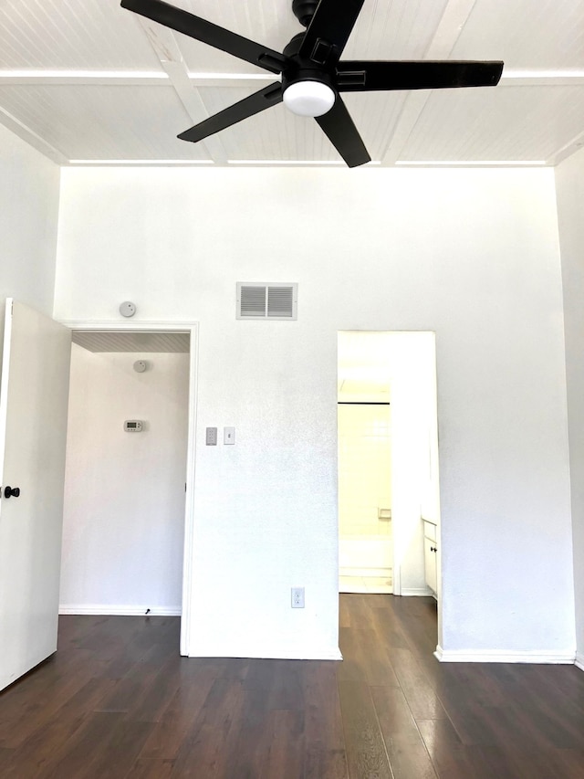 spare room featuring baseboards, wood finished floors, visible vents, and ceiling fan