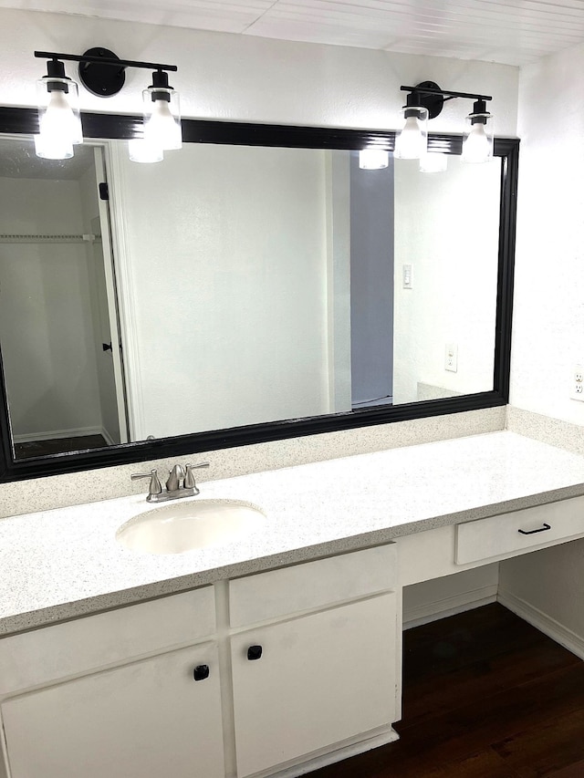 bathroom with wood finished floors and vanity