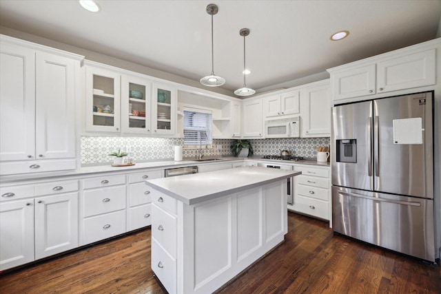 kitchen featuring white cabinets, appliances with stainless steel finishes, and dark wood-type flooring