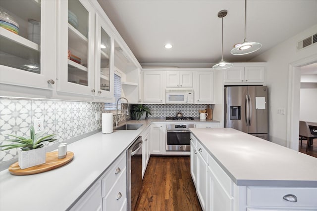 kitchen featuring visible vents, appliances with stainless steel finishes, light countertops, and a sink