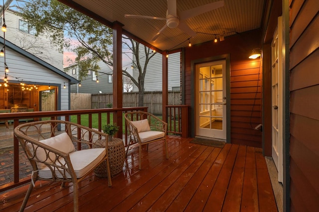 deck with ceiling fan and fence