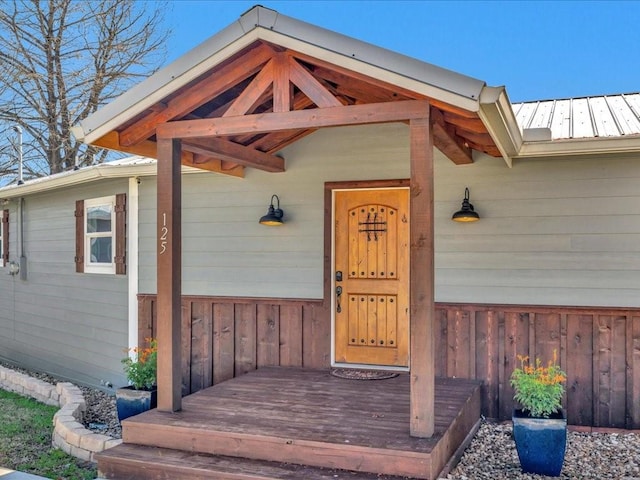 doorway to property featuring metal roof