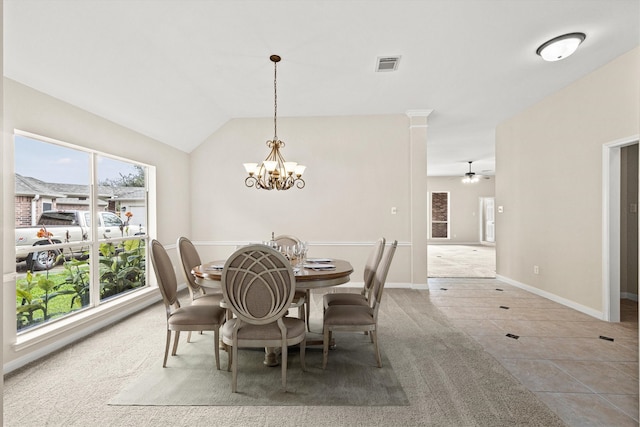 tiled dining room featuring ceiling fan with notable chandelier, lofted ceiling, baseboards, and visible vents