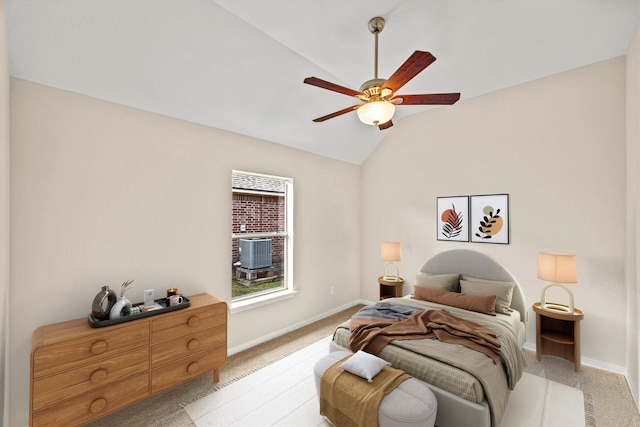 bedroom with vaulted ceiling, a ceiling fan, baseboards, and light carpet