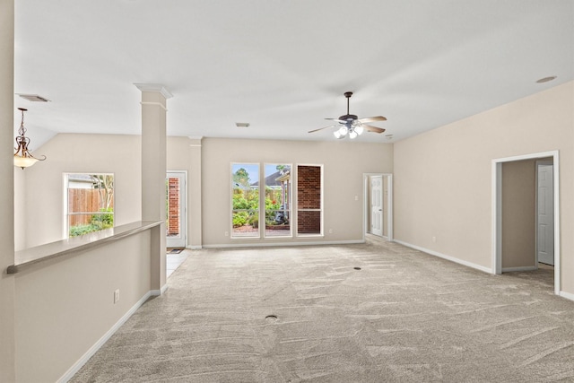 unfurnished living room featuring visible vents, baseboards, carpet flooring, a ceiling fan, and ornate columns