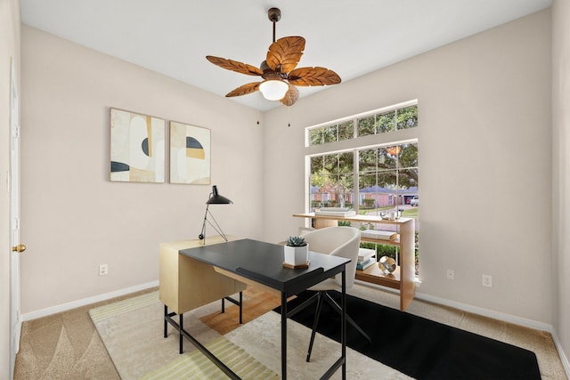 home office featuring carpet, baseboards, and ceiling fan