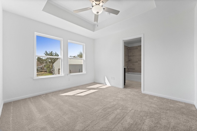 11837 E Gate Dr, Willis, TX 77318 - carpeted empty room with a ceiling fan, a raised ceiling, and baseboards