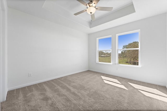 11837 E Gate Dr, Willis, TX 77318 - carpeted spare room featuring a raised ceiling, a ceiling fan, and baseboards