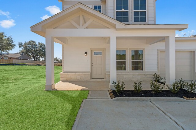 11837 E Gate Dr, Willis, TX 77318 - view of exterior entry featuring a yard, stone siding, and fence