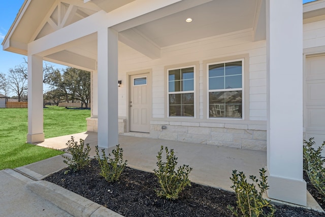 11837 E Gate Dr, Willis, TX 77318 - doorway to property featuring stone siding, a lawn, and a porch