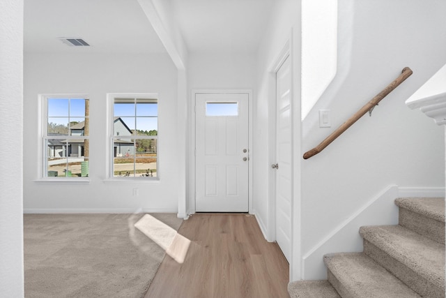 11837 E Gate Dr, Willis, TX 77318 - foyer featuring stairway, baseboards, visible vents, and light carpet