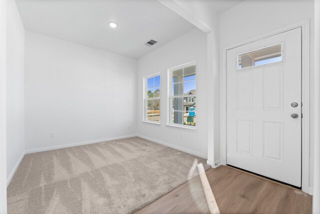 11837 E Gate Dr, Willis, TX 77318 - carpeted foyer entrance featuring recessed lighting, visible vents, baseboards, and wood finished floors