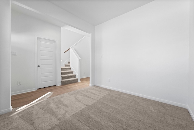11837 E Gate Dr, Willis, TX 77318 - empty room featuring stairs, baseboards, and carpet floors