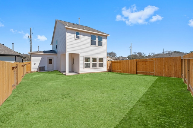 11837 E Gate Dr, Willis, TX 77318 - rear view of house with central air condition unit, a lawn, and a fenced backyard