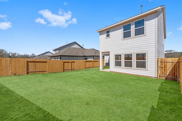11837 E Gate Dr, Willis, TX 77318 - back of property with a lawn and a fenced backyard