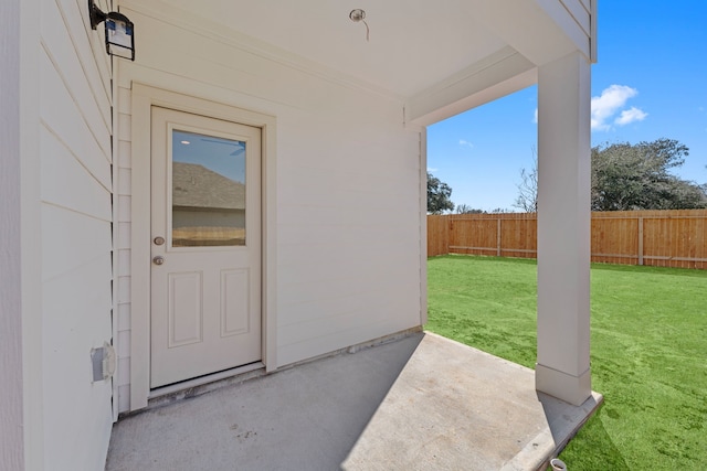11837 E Gate Dr, Willis, TX 77318 - view of exterior entry featuring a patio area, fence, and a lawn