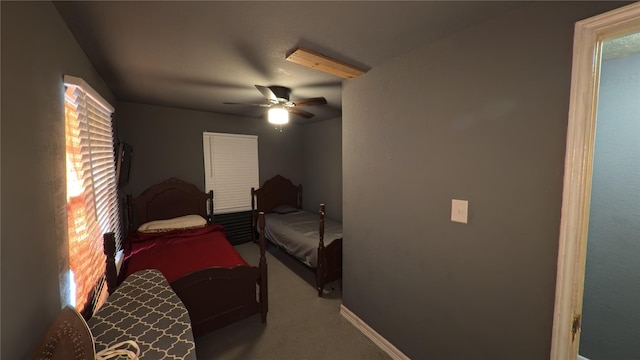 carpeted bedroom featuring baseboards and a ceiling fan