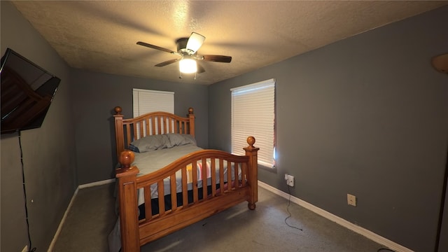 bedroom featuring ceiling fan, carpet flooring, baseboards, and a textured ceiling