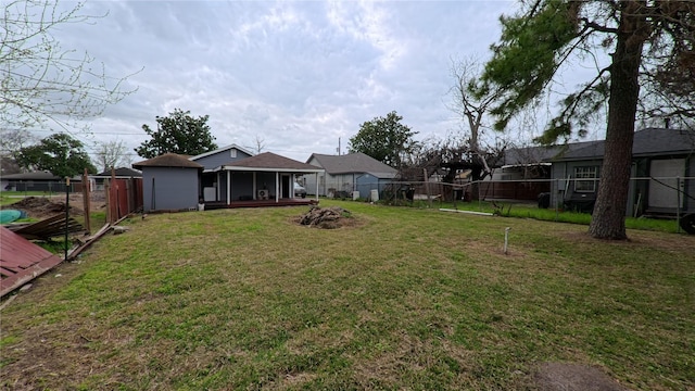 view of yard with a fenced backyard and a sunroom