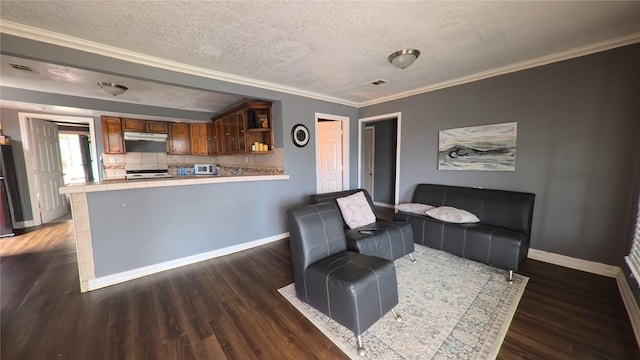 sitting room with visible vents, a textured ceiling, wood finished floors, crown molding, and baseboards