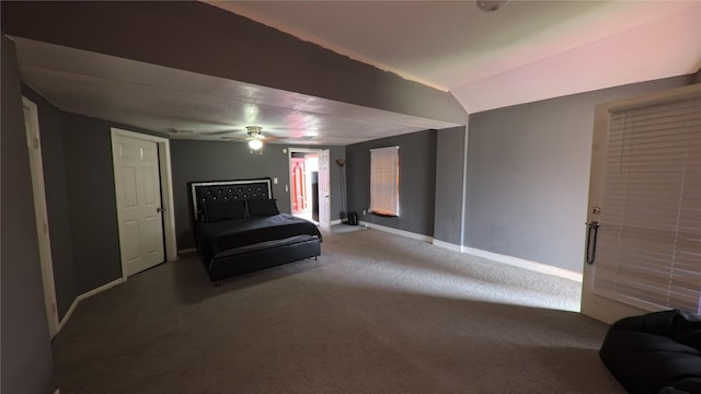 carpeted bedroom featuring vaulted ceiling, baseboards, and ceiling fan