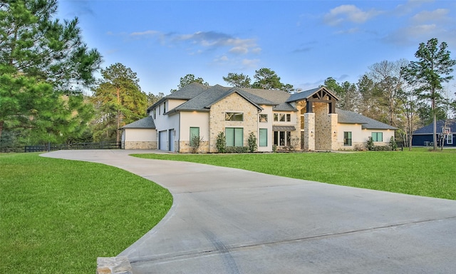 view of front of house with a garage, fence, a front lawn, and stucco siding