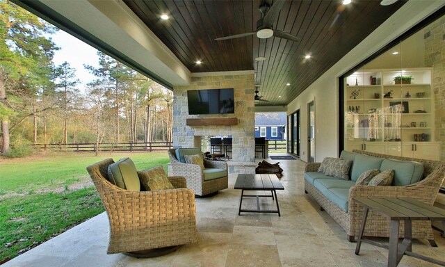 view of patio with outdoor lounge area, fence, and ceiling fan