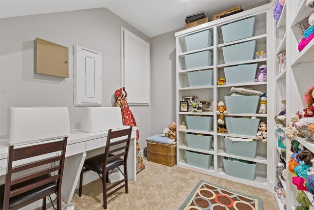 home office with lofted ceiling and carpet flooring