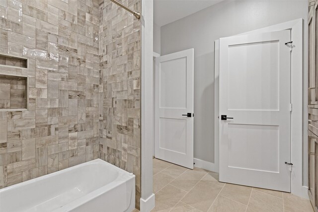 bathroom with tile patterned floors and shower / bath combination