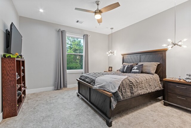 bedroom featuring visible vents, light carpet, baseboards, and ceiling fan with notable chandelier