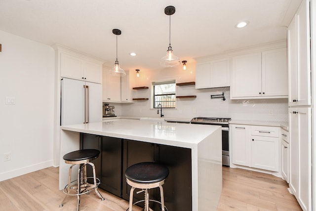 kitchen with light countertops, stainless steel range with electric stovetop, light wood-style floors, white cabinets, and open shelves