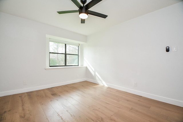 unfurnished room with ceiling fan, light wood-type flooring, and baseboards